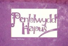 A laser cut card with the welsh word Penblwydd Hapus