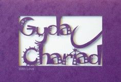 A laser cut card with the welsh word Gyda Chariad