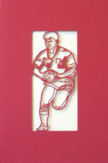 A Welsh greetings card laser cut card with a Welsh emblem representing a rugby player