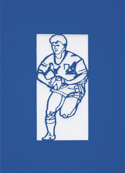 A Welsh greetings card laser cut card with a Welsh emblem representing a rugby player