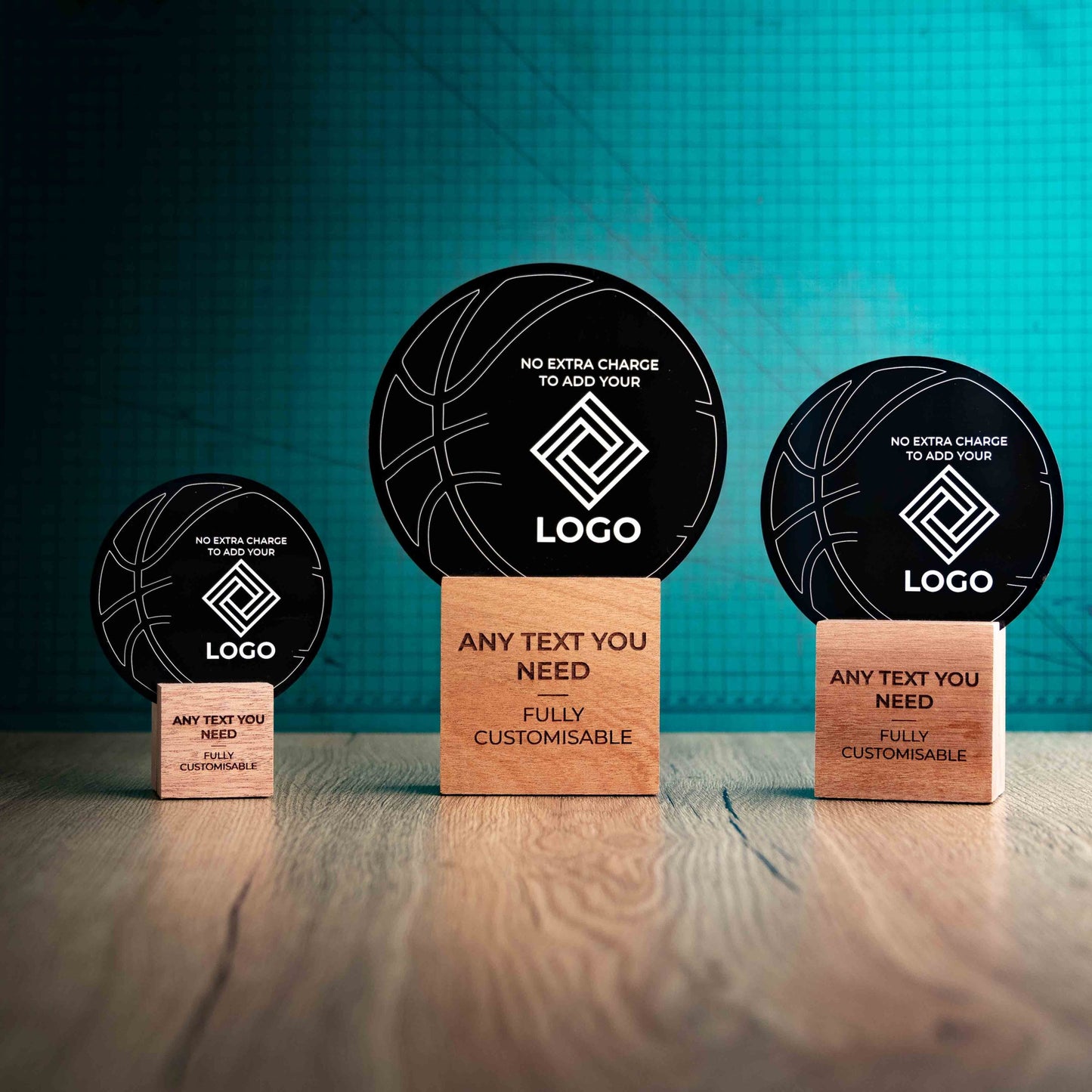 Three Basketball trophies with custom text and logos, on eco-friendly wooden bases, with a black Perspex Basketball mounted on top, featuring fully customisable areas for text and logos.