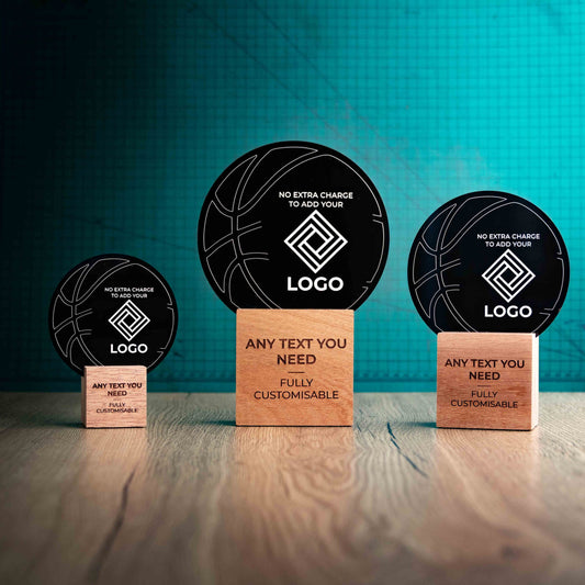 Three Basketball trophies with custom text and logos, on eco-friendly wooden bases, with a black Perspex Basketball mounted on top, featuring fully customisable areas for text and logos.