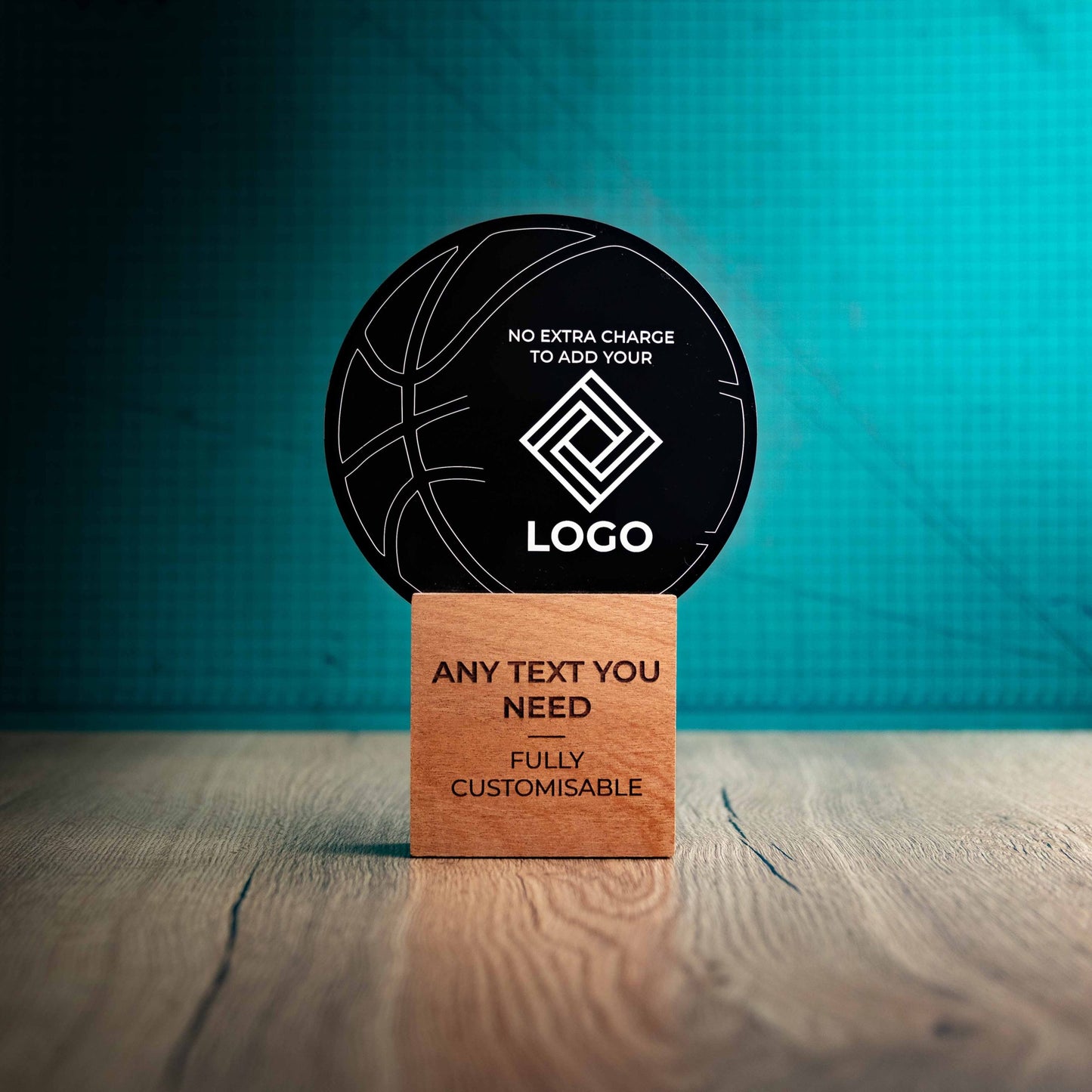 A large Basketball trophy with custom text and logos, on an eco-friendly wooden base, with a black Perspex Basketball mounted on top, featuring fully customisable areas for text and logos.