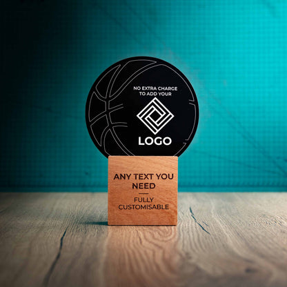 A large Basketball trophy with custom text and logos, on an eco-friendly wooden base, with a black Perspex Basketball mounted on top, featuring fully customisable areas for text and logos.