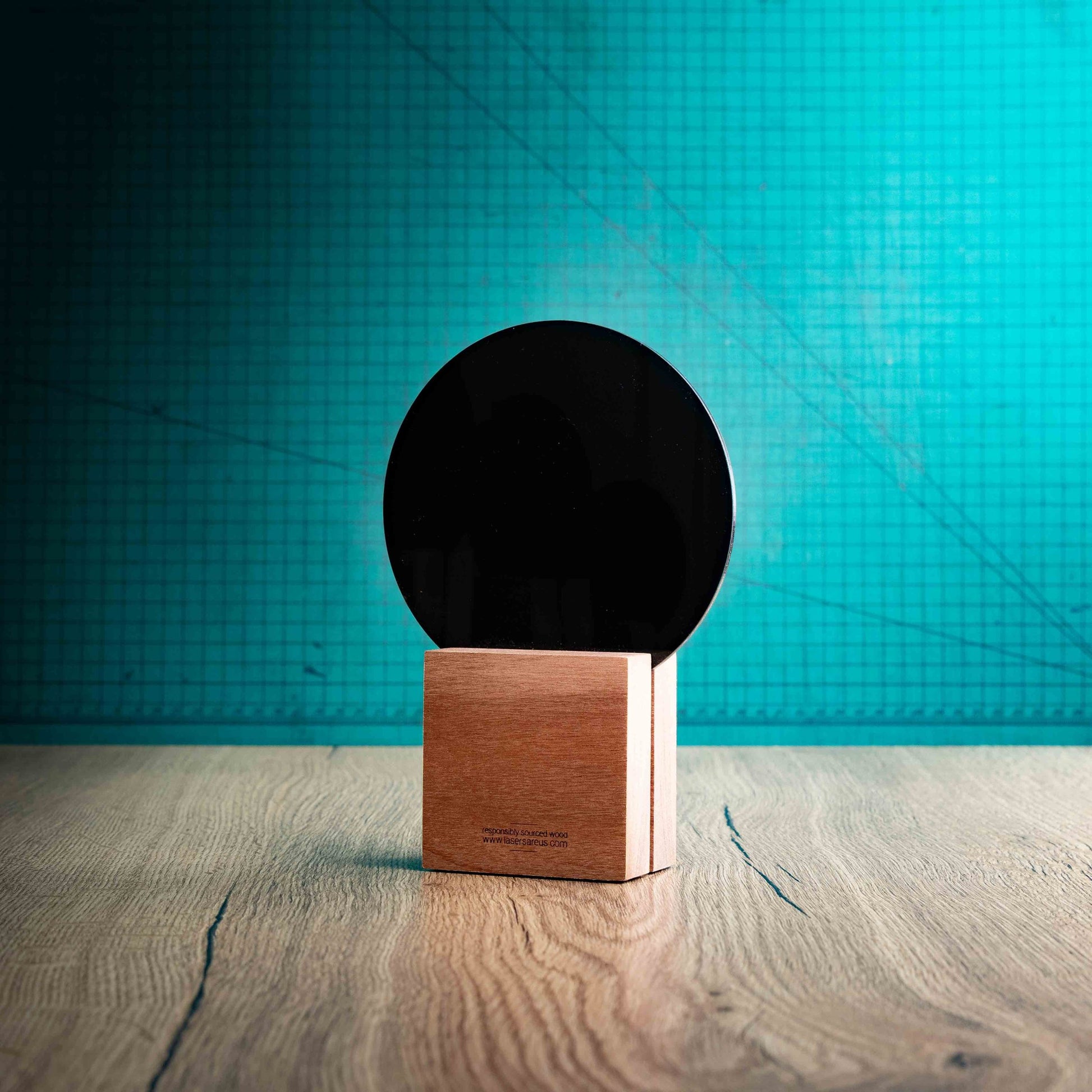 A back view of a medium Basketball trophy with custom text and logos, on an eco-friendly wooden base, with a black Perspex Basketball mounted on top, featuring fully customisable areas for text and logos.