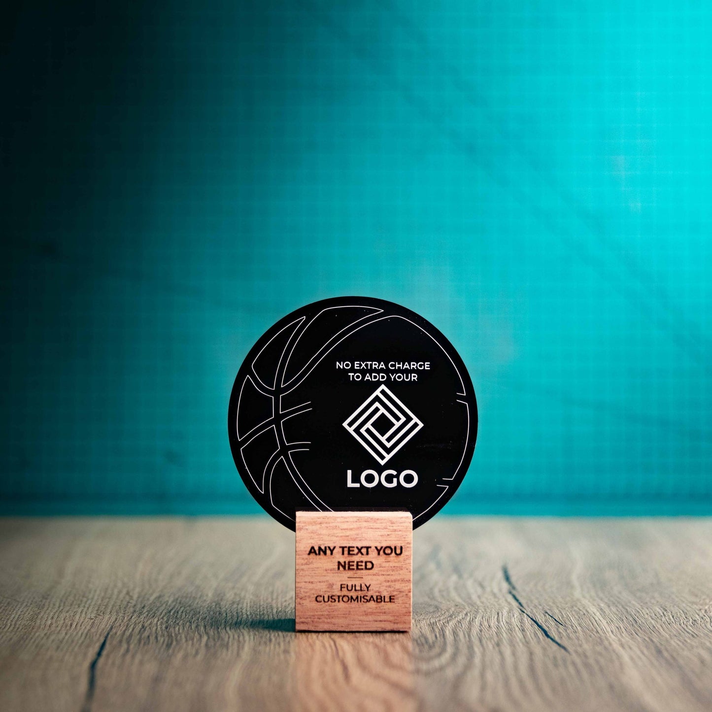 A small Basketball trophy with custom text and logos, on an eco-friendly wooden base, with a black Perspex Basketball mounted on top, featuring fully customisable areas for text and logos.