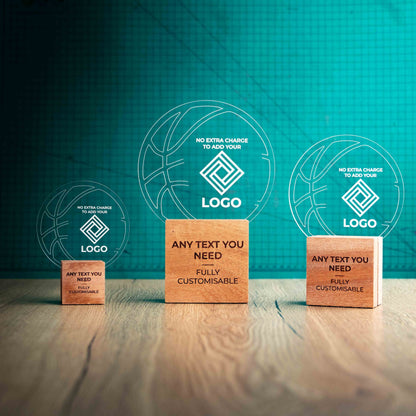 Three Basketball trophies with custom text and logos, on eco-friendly wooden bases, with a clear Perspex Basketball mounted on top, featuring fully customisable areas for text and logos.
