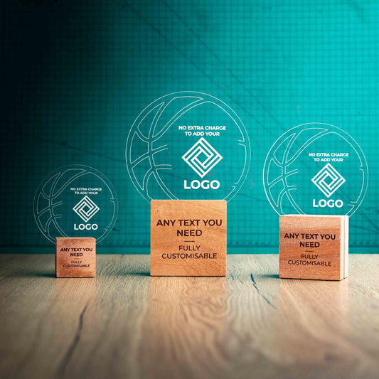 Three Basketball trophies with custom text and logos, on eco-friendly wooden bases, with a clear Perspex Basketball mounted on top, featuring fully customisable areas for text and logos.