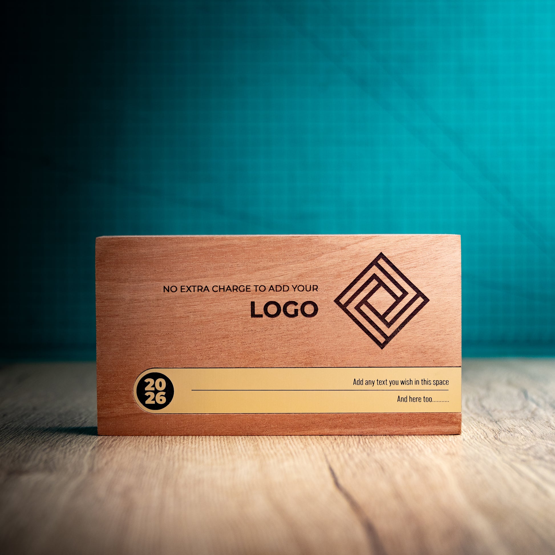 Front view of the large landscape Bezel wooden trophy with an engraved logo, wide gold metallic personalisation inlay and circular 2026 detail at the left.