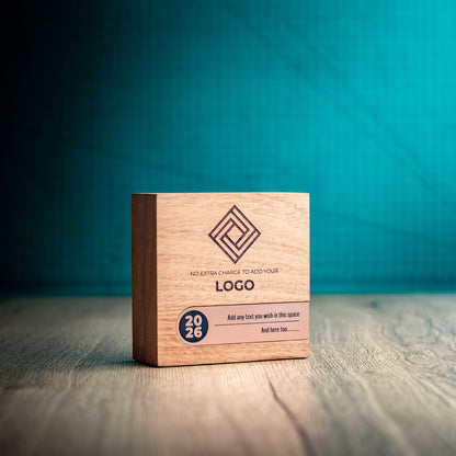 Three-quarter view of the small Bezel wooden trophy showing its compact block shape, engraved front and bronze-coloured metallic personalisation inlay across the lower section.