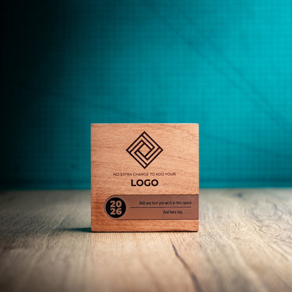 Straight-on front view of the small Bezel wooden trophy with an engraved logo, bronze metallic personalisation inlay and circular 2026 detail at the left.