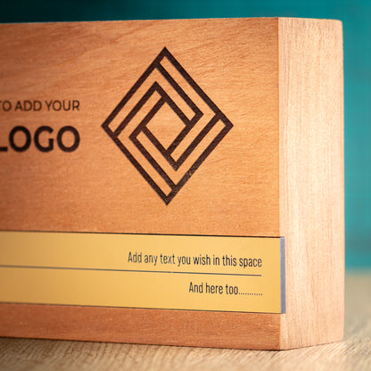 Close-up angled view of the large Bezel wooden trophy showing the engraved geometric logo, thick wood construction and gold metallic inlay across the lower front.