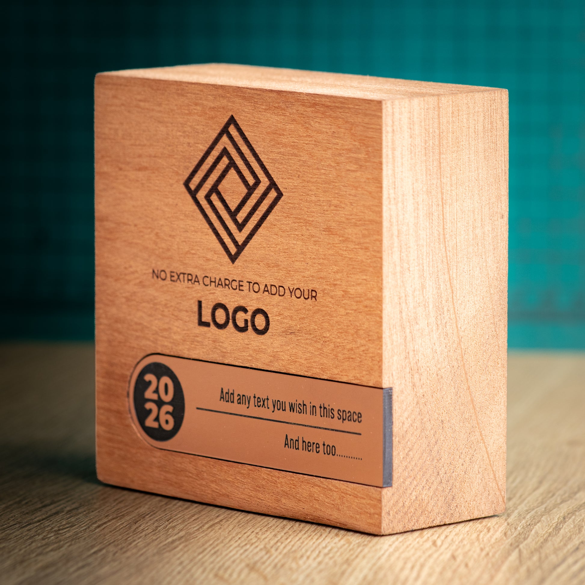 Three-quarter view of a Bezel wooden trophy showing its substantial wood depth, engraved front and bronze metallic personalisation inlay across the lower section.