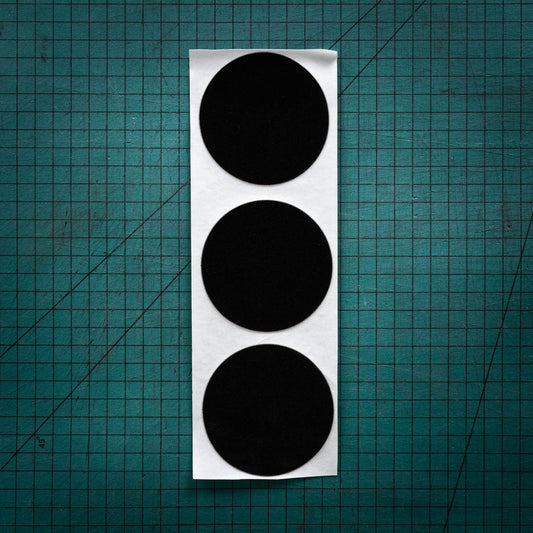 Black baize circles, sometimes known as felt, laser cut into three big circles