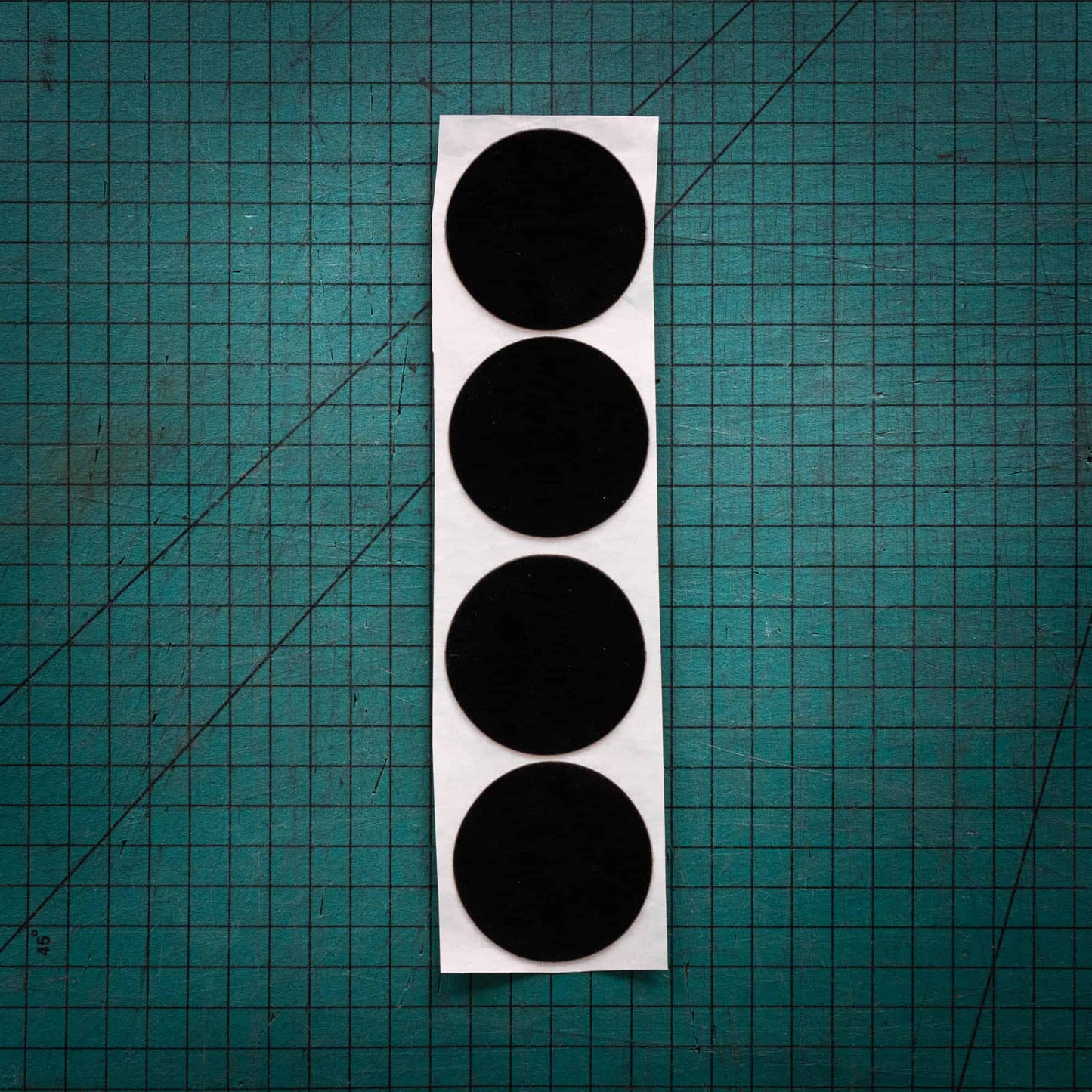 Black baize circles, sometimes known as felt, laser cut into circles