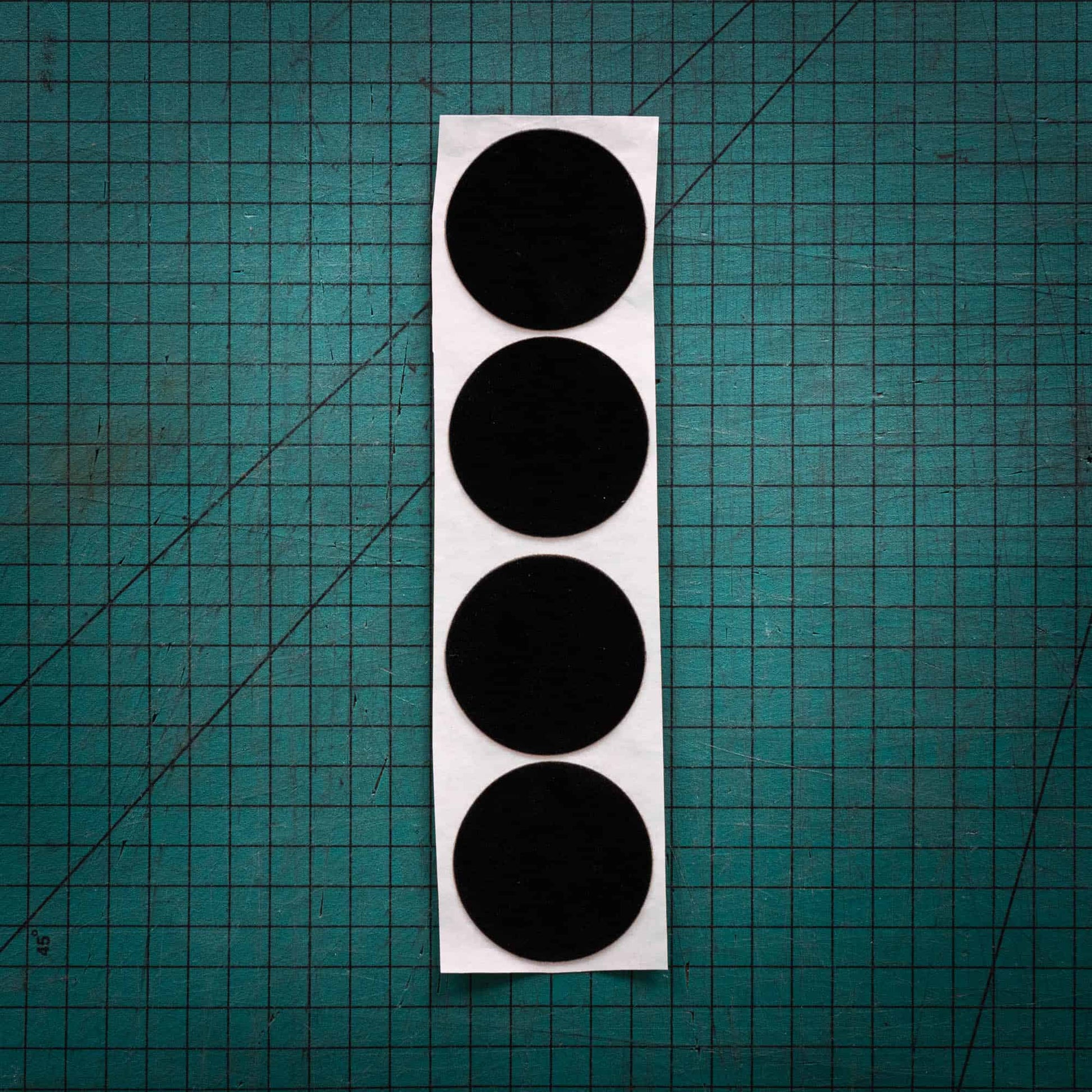Black baize circles, sometimes known as felt, laser cut into circles