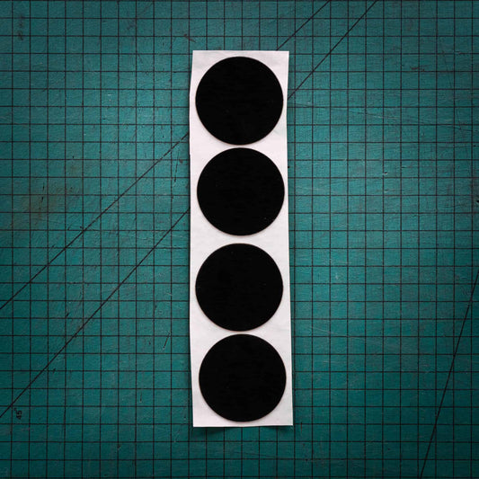 Black baize circles, sometimes known as felt, laser cut into circles