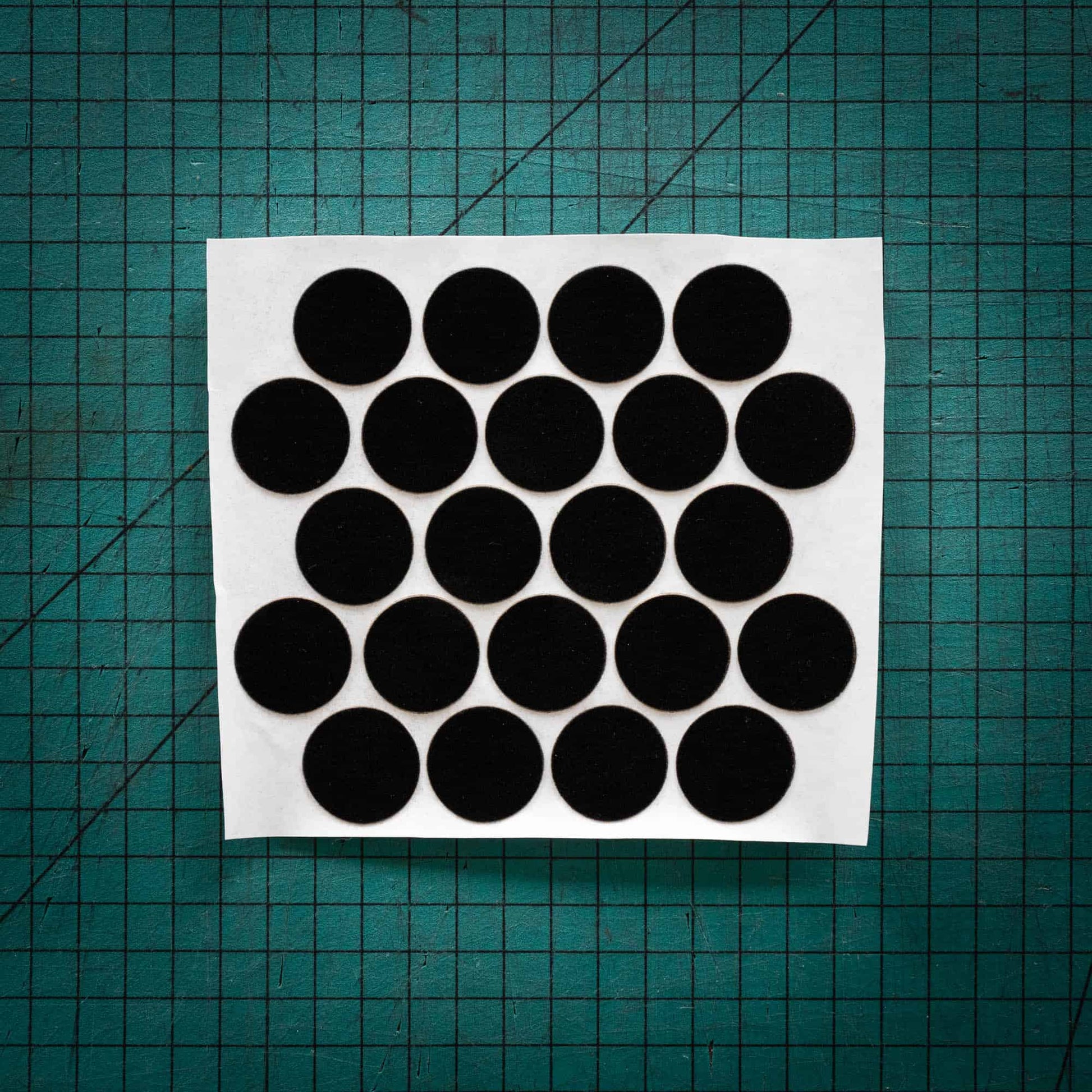 Black baize circles, sometimes known as felt, laser cut into circles