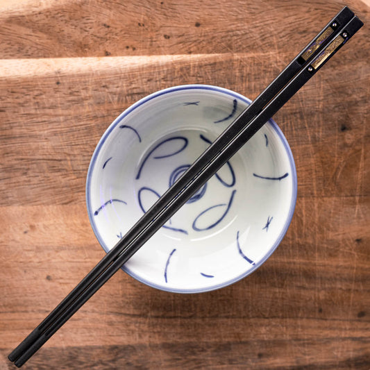 A personalised pair of black premium plastic chopsticks laser engraved
