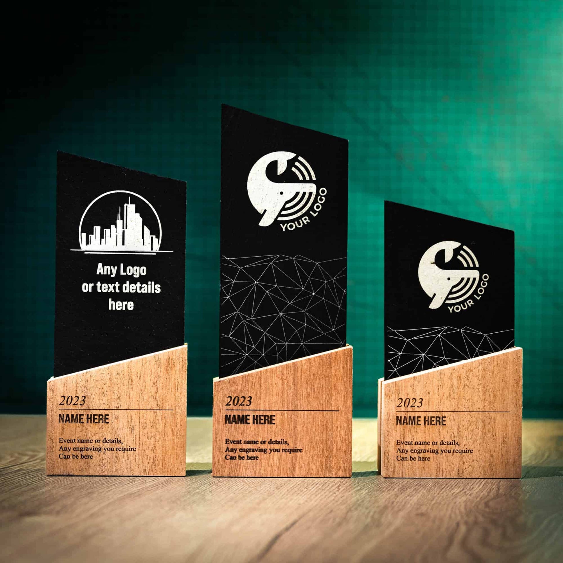 Three Wooden and Slate trophies, a range of Trophies called the Blade Award. The Blade trophies consist of an Eco-friendly base with a block of Welsh Snowdonian Slate rising out of it to an off-centre point. They are personalised with the details of the event and a logo.