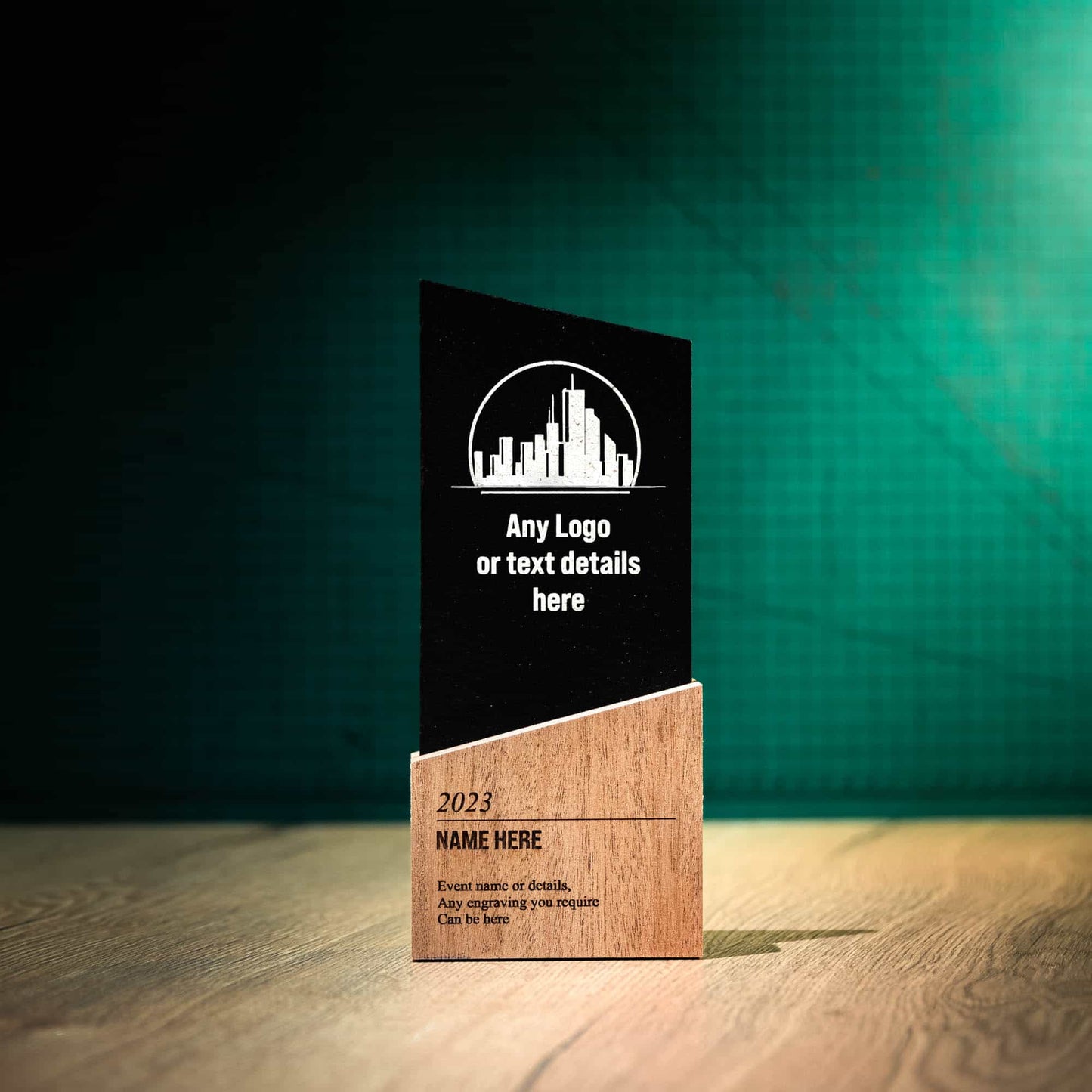 A medium laser-engraved, eco-friendly, wooden and slate trophy called The Blade Award. The Blade trophies consist of an Eco-friendly base with a block of Welsh Snowdonian Slate rising out of it to an off-centre point. They are personalised with the details of the event and a logo.