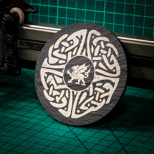 A laser engraved Welsh slate coaster with a welsh dragon in the center of a celtic knot