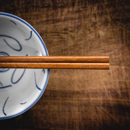 A pair of personalised dark wood Chinese Chopsticks, personalised with a name translated into Chinese