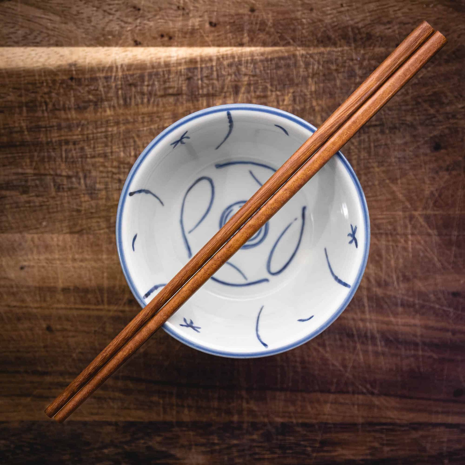 A pair of personalised dark wood Chinese Chopsticks, personalised with a name translated into Chinese