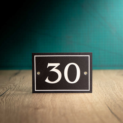A rectangular Welsh Slate House Plaque with a color filled house number and boarder