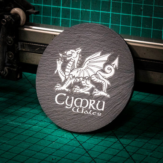 A laser engraved Welsh slate coaster with a welsh dragon and the words cymru and wales