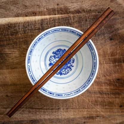 A pair of personalised dark wood Chinese Chopsticks, personalised with a name translated into Chinese