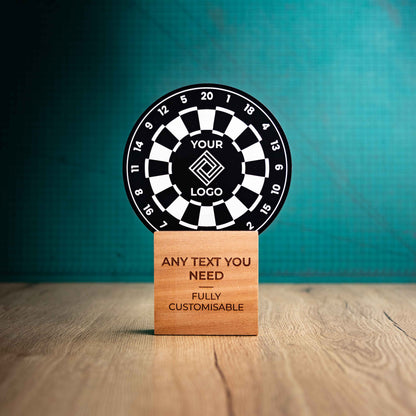 A large darts trophy with custom text and logos, on an eco-friendly wooden base, with a black Perspex dart board mounted on top, featuring fully customisable areas for text and logos.