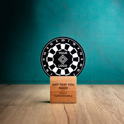 A medium darts trophy with custom text and logos, on an eco-friendly wooden base, with a black Perspex dart board mounted on top, featuring fully customisable areas for text and logos.