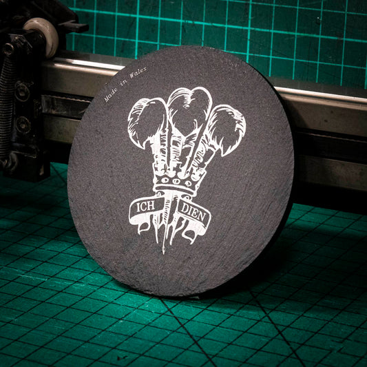 A laser engraved Welsh slate coaster with the welsh three feathers