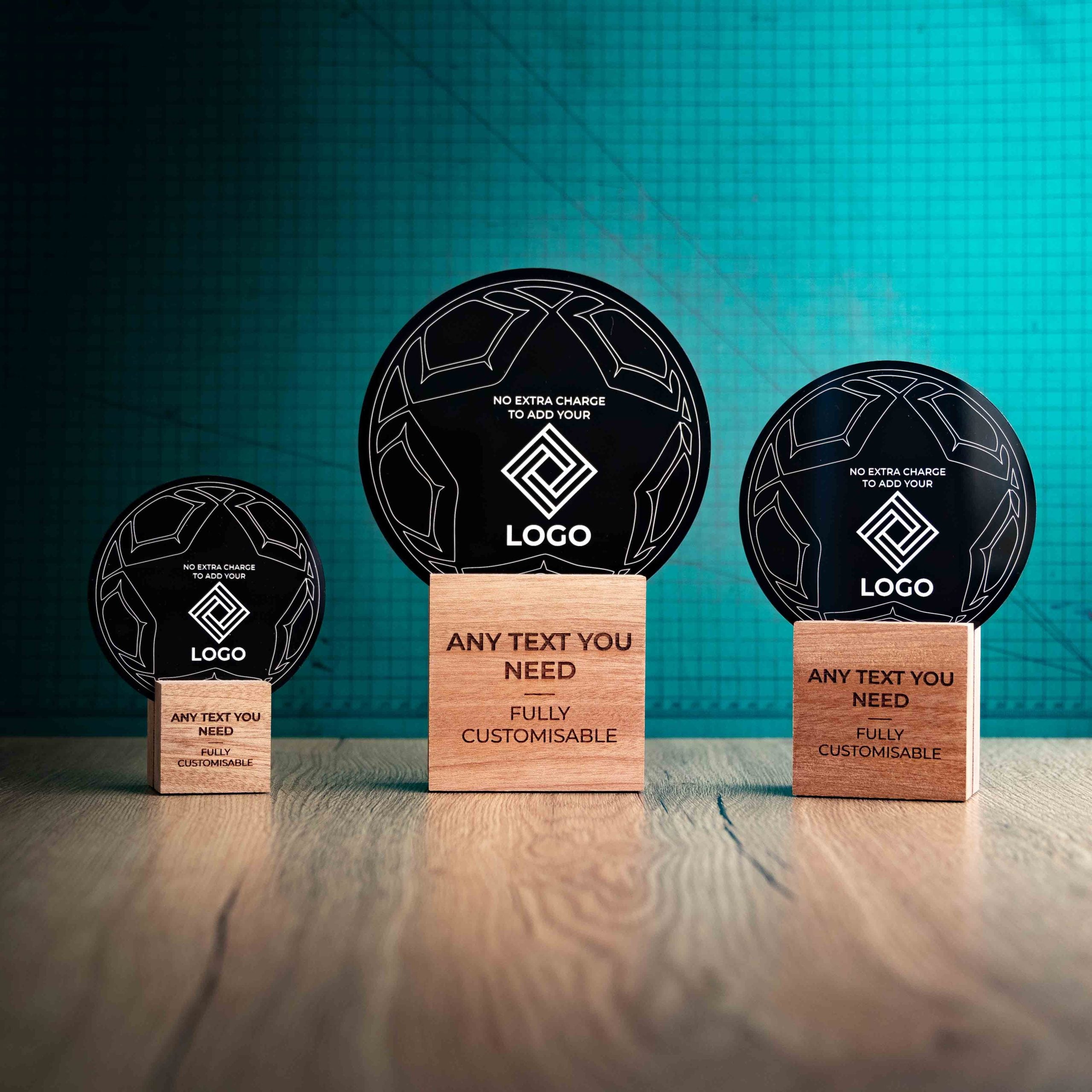 Three football trophies with custom text and logos, on eco-friendly wooden bases, with a black Perspex football mounted on top, featuring fully customisable areas for text and logos.