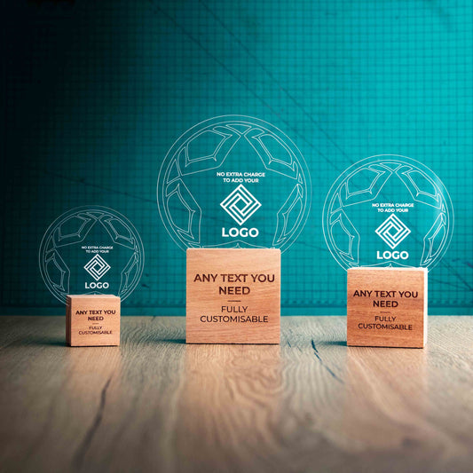 Three football trophies with custom text and logos, on eco-friendly wooden bases, with a clear Perspex football mounted on top, featuring fully customisable areas for text and logos