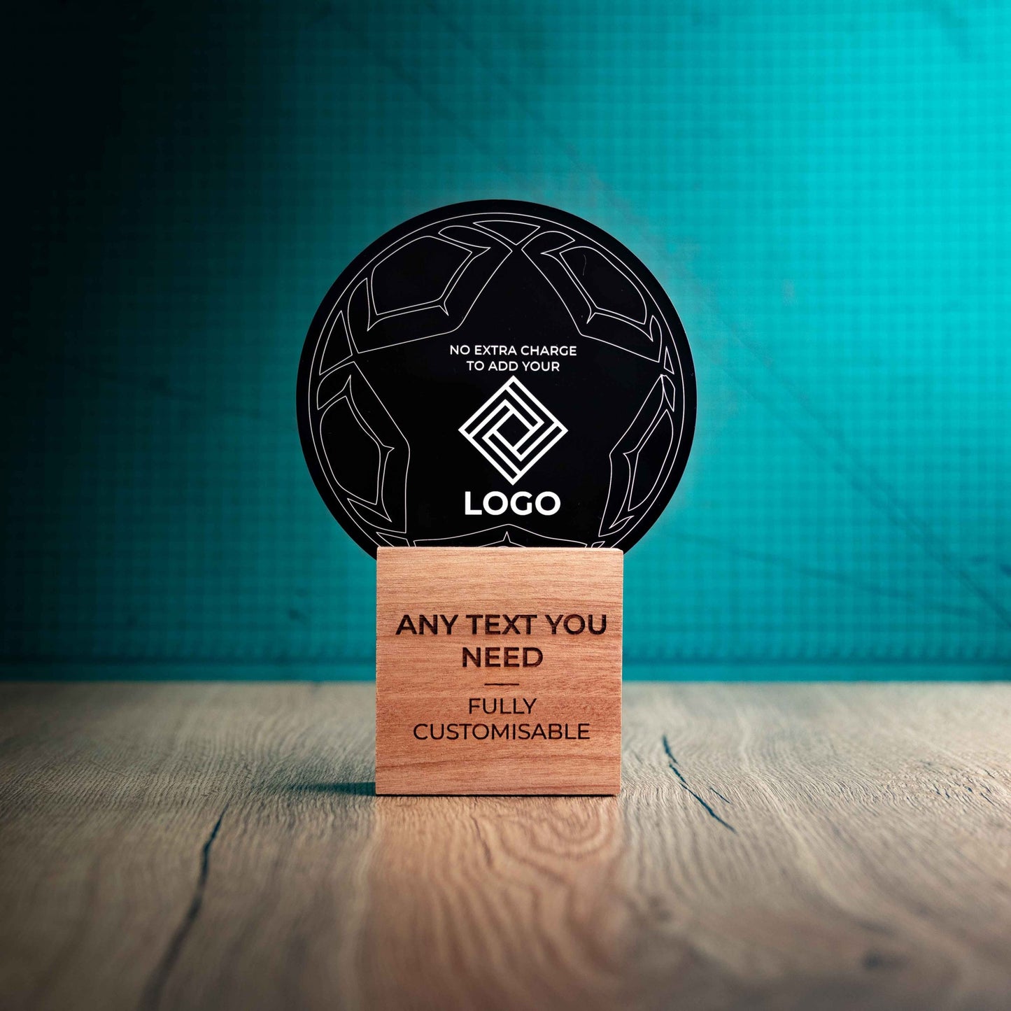 A large football trophy with custom text and logos, on an eco-friendly wooden base, with a black Perspex football mounted on top, featuring fully customisable areas for text and logos.