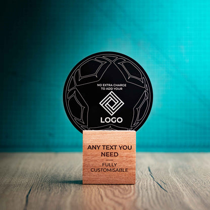 A medium football trophy with custom text and logos, on an eco-friendly wooden base, with a black Perspex football mounted on top, featuring fully customisable areas for text and logos.