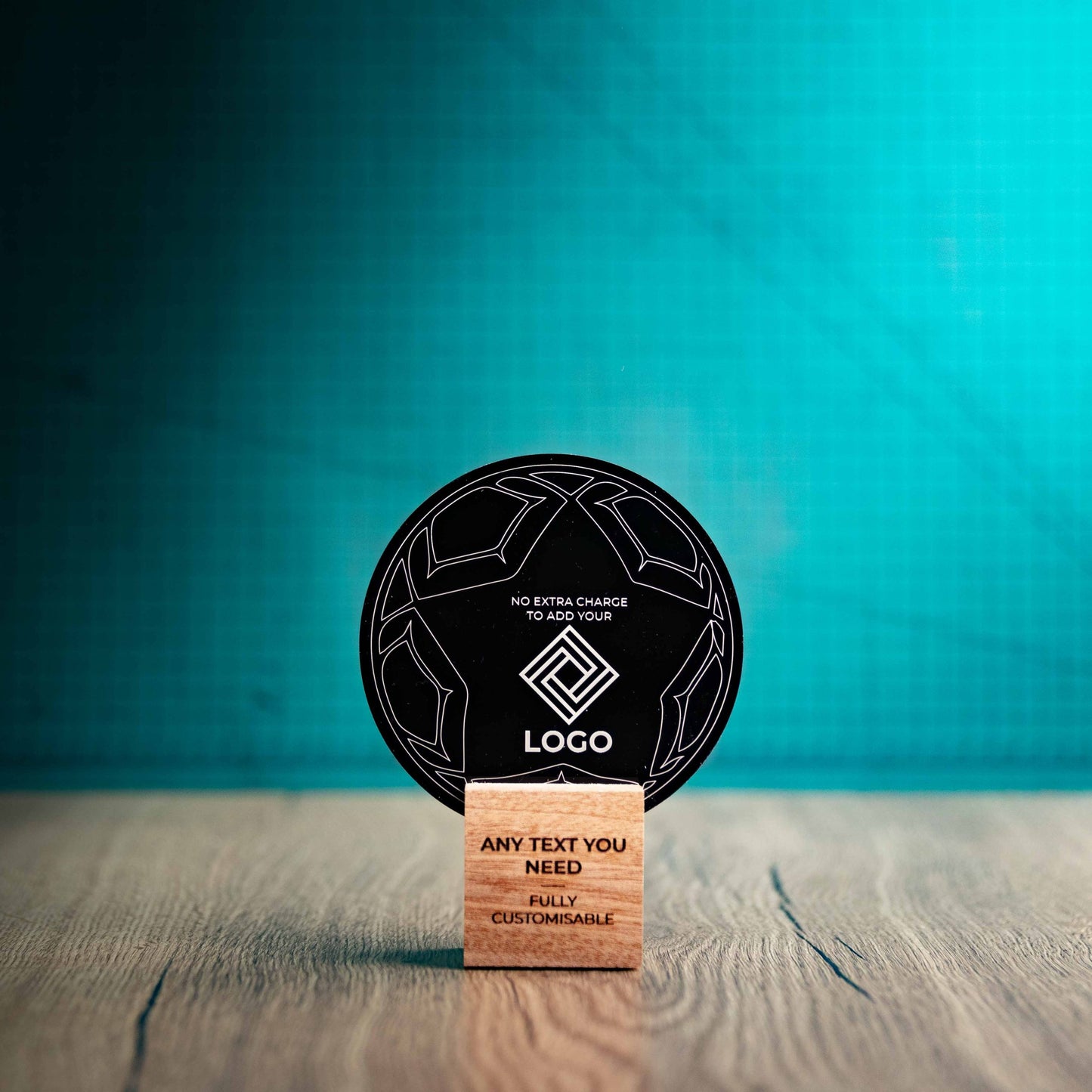 A small football trophy with custom text and logos, on an eco-friendly wooden base, with a black Perspex football mounted on top, featuring fully customisable areas for text and logos.