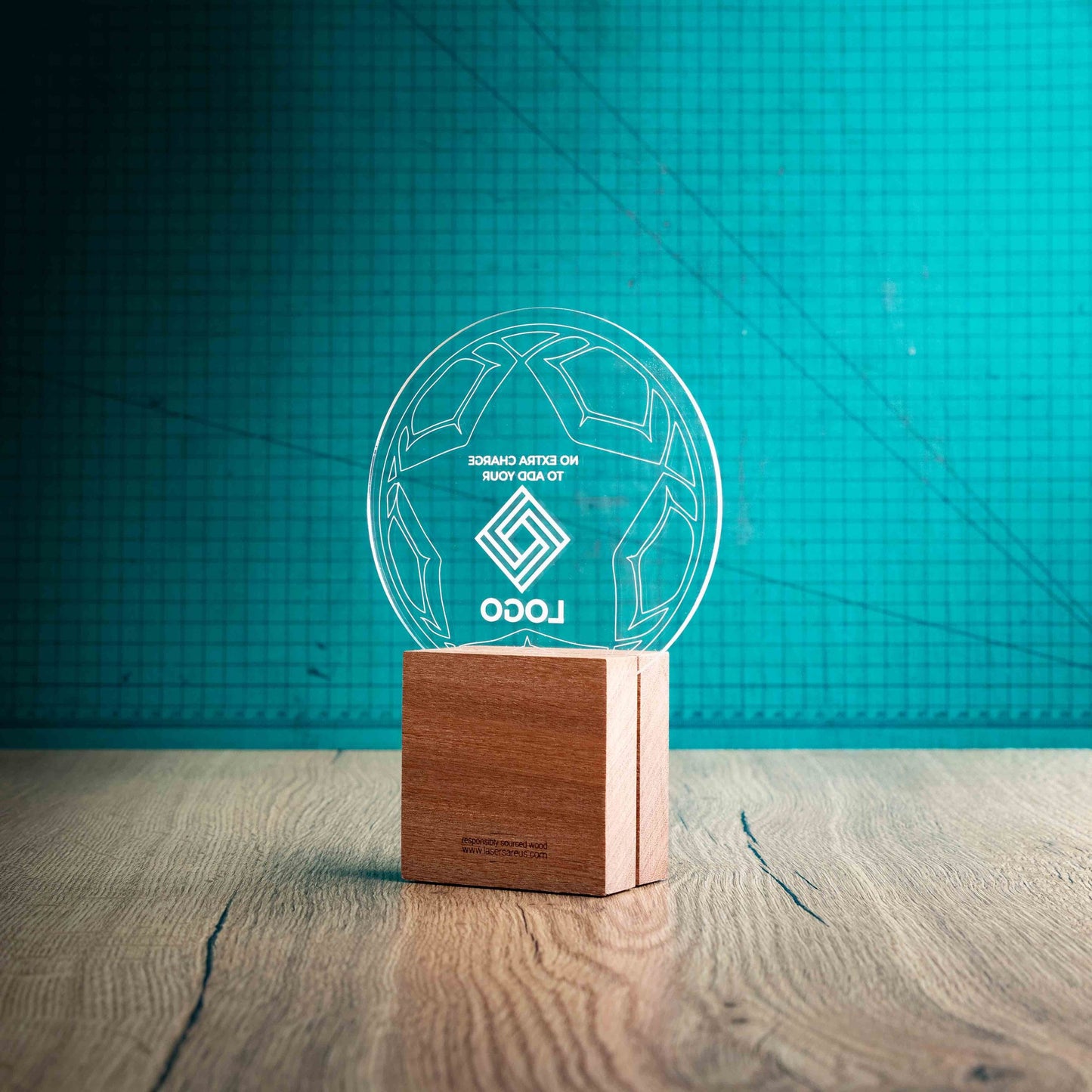 A view of the back of a medium football trophy with custom text and logos, on an eco-friendly wooden base, with a clear Perspex football mounted on top, featuring fully customisable areas for text and logos.