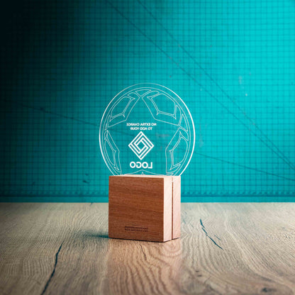 A view of the back of a medium football trophy with custom text and logos, on an eco-friendly wooden base, with a clear Perspex football mounted on top, featuring fully customisable areas for text and logos.