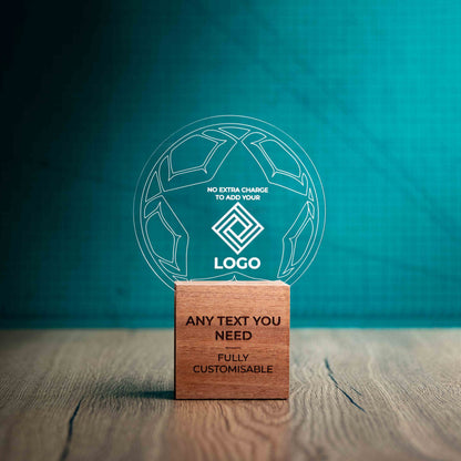 A medium football trophy with custom text and logos, on an eco-friendly wooden base, with a clear Perspex football mounted on top, featuring fully customisable areas for text and logos.