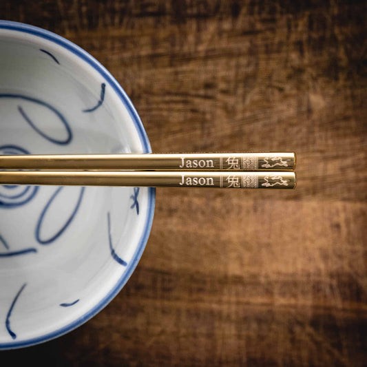 A pair of personalised Gold Chinese Zodiac Chopsticks, Rabbit, laser engraved with a name of your choice