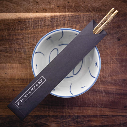 A pair of personalised Gold Chinese Zodiac Chopsticks, Rabbit, laser engraved with a name of your choice, in a black paper pouch