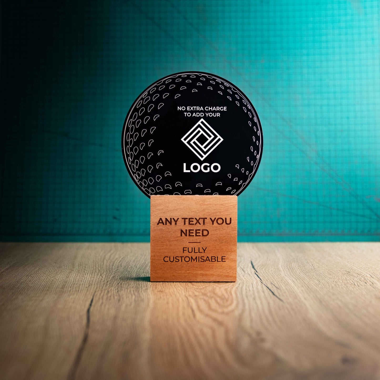 A large golf award trophy with custom text and logos, on an eco-friendly wooden base, with a black Perspex golf ball mounted on top, with fully customisable areas featuring fully customisable areas for text and logos.