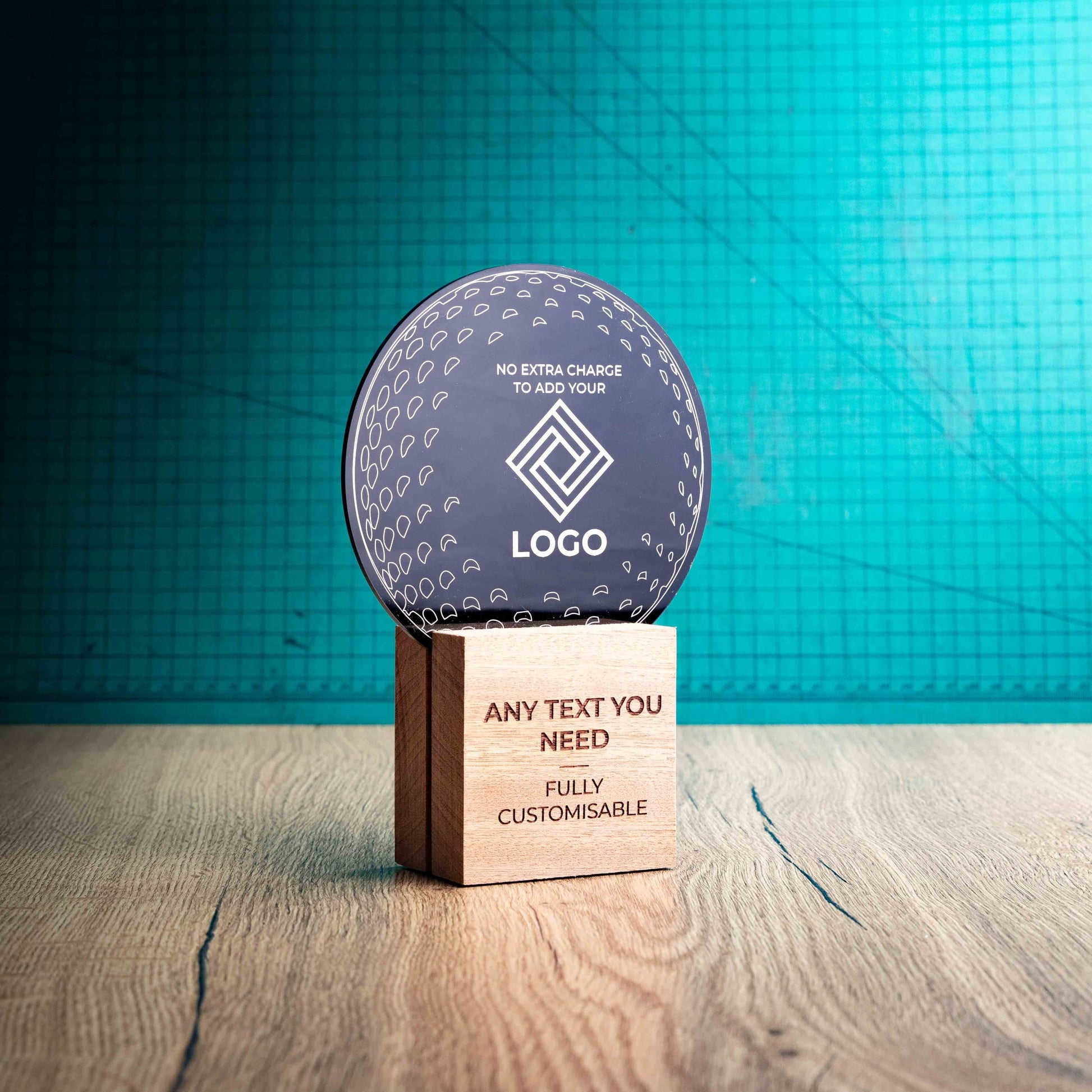 A side view of a medium golf award trophy with custom text and logos, on an eco-friendly wooden base, with a black Perspex golf ball mounted on top, with fully customisable areas featuring fully customisable areas for text and logos.