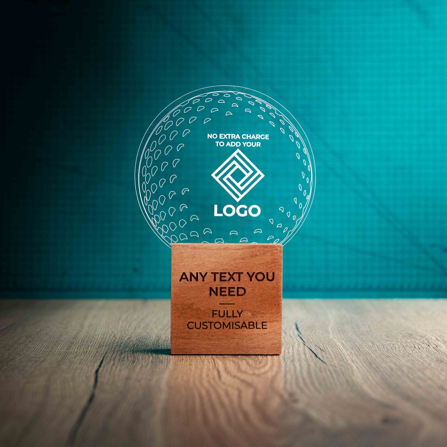 A large golf award trophy with custom text and logos, on an eco-friendly wooden base, with a clear Perspex golf ball mounted on top, with fully customisable areas featuring fully customisable areas for text and logos.