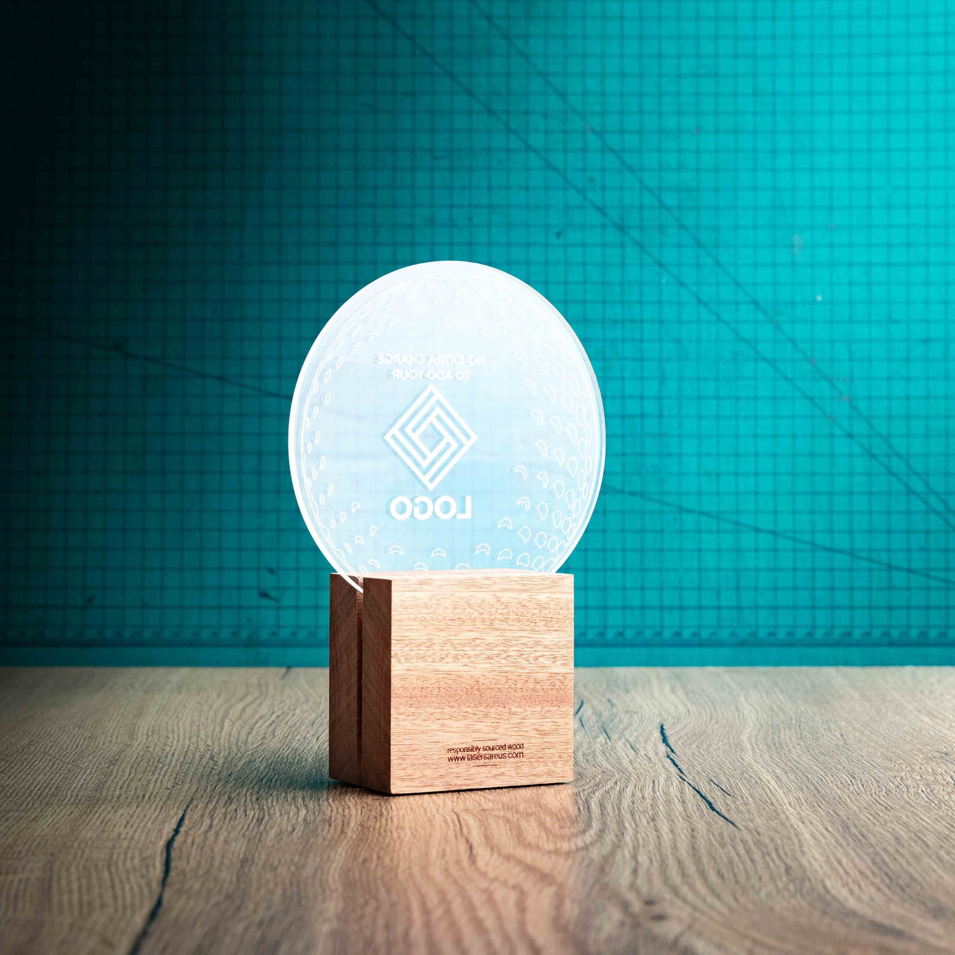 A view of the back of a medium golf award trophy with custom text and logos, on an eco-friendly wooden base, with a clear Perspex golf ball mounted on top, with fully customisable areas featuring fully customisable areas for text and logos.