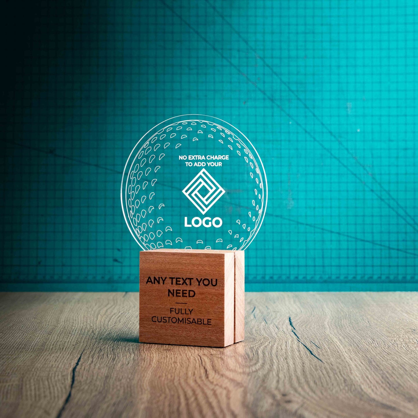 A side view of a medium golf award with custom text and logos, on an eco-friendly wooden base, with a clear Perspex golf ball mounted on top, with fully customisable areas featuring fully customisable areas for text and logos.