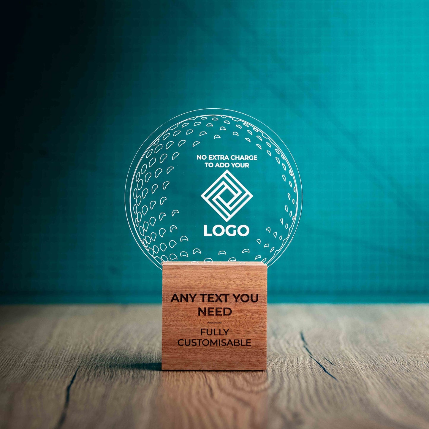 A medium golf award trophy with custom text and logos, on an eco-friendly wooden base, with a clear Perspex golf ball mounted on top, with fully customisable areas featuring fully customisable areas for text and logos.